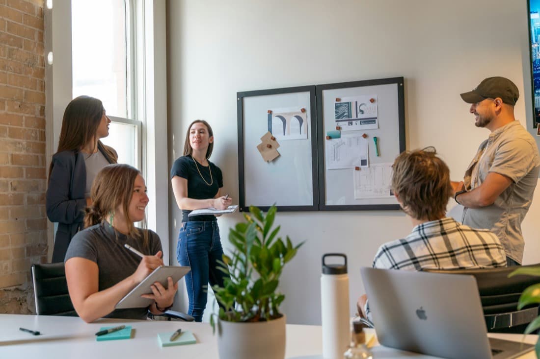 A speaker talking to a small group in a bright room